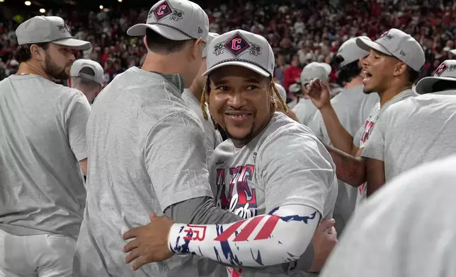 Cleveland Guardians third baseman José Ramírez, center, celebrates after Game 5 of baseball's American League Division Series against the Chicago White Sox, Saturday, Oct. 10, 2026, in Cleveland. (AP Photo/Sue Ogrocki)