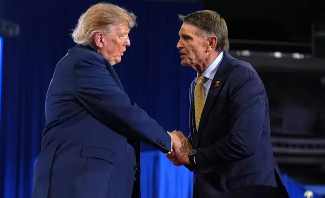 Kentucky Republican congressional candidate Ed Gallrein, right, shakes the hand of President Donald Trump at a campaign rally at Truist Arena at Northern Kentucky University, Saturday, Oct. 17, 2026, in Highland Heights, Ky. (AP Photo/Mark Schiefelbein)