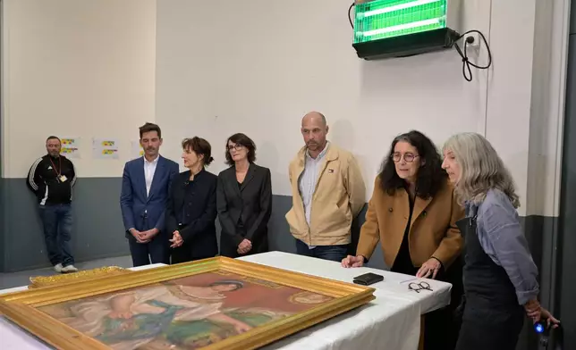 Recovered paintings "Portrait of Madame Colonna Romano" and "Young Woman at the Well," stolen from the Renoir Museum in Cagnes-sur-Mer are on display at the Interdisciplinary Centre for the Conservation and Restoration of Heritage in Marseille, France, Monday Oct. 12, 2026. (AP Photo/Philippe Magoni)