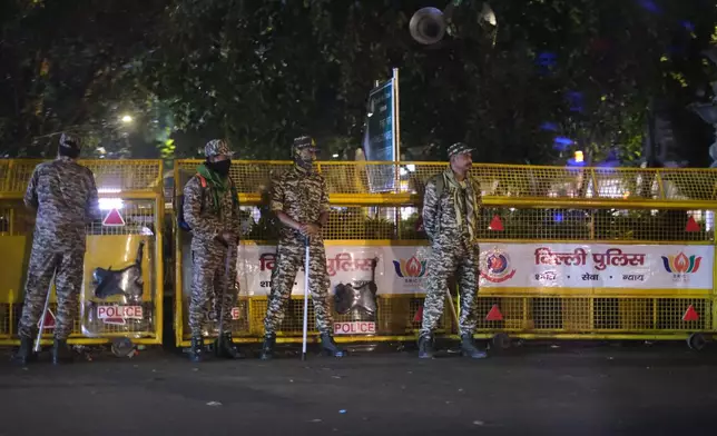 Soldiers stand guard by a barricade in the heart of New Delhi, India, Monday, Oct. 12, 2026. (AP Photo/Yirmiyan Arthur)
