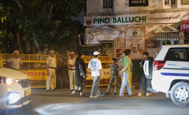 Policemen stand guard by a barricade in the heart of New Delhi, India, Monday, Oct. 12, 2026. (AP Photo/Yirmiyan Arthur)