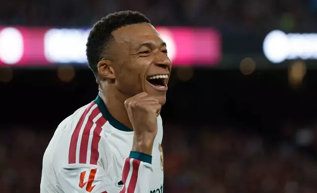 Real Madrid's Kylian Mbappe celebrates after scoring his side's opening goal during a Spanish La Liga soccer match between FC Barcelona and Real Madrid in Barcelona, Spain, Sunday, Oct. 25, 2026. (AP Photo/Joan Monfort)