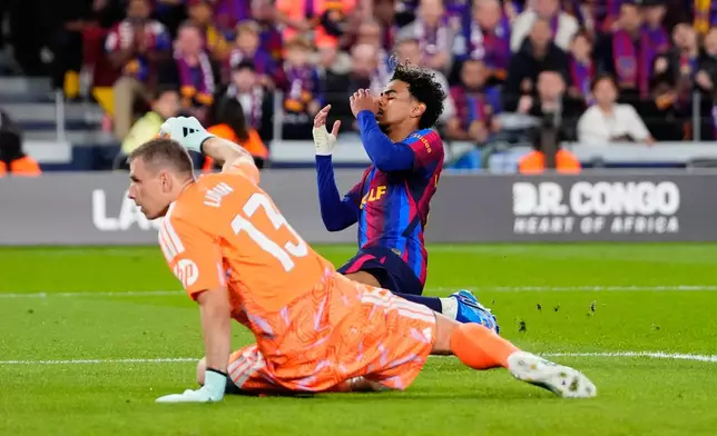 Barcelona's Lamine Yamal, right, reacts after a missed scoring opportunity during a Spanish La Liga soccer match between FC Barcelona and Real Madrid in Barcelona, Spain, Sunday, Oct. 25, 2026. (AP Photo/Jose Breton)