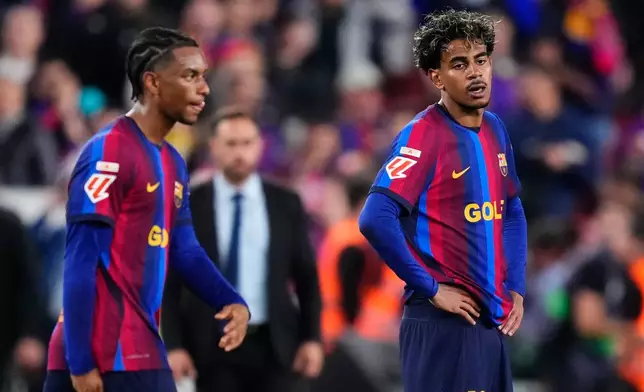 Barcelona's Lamine Yamal, right, and Barcelona's Alejandro Balde react at the end of the Spanish La Liga soccer match between FC Barcelona and Real Madrid in Barcelona, Spain, Sunday, Oct. 25, 2026. (AP Photo/Jose Breton)