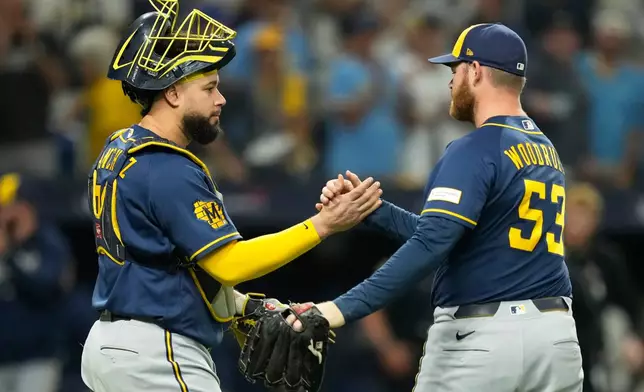 Milwaukee Brewers pitcher Brandon Woodruff celebrates their win with catcher Gary Sánchez in Game 3 of baseball's World Series, Monday, Oct. 26, 2026, in St. Petersburg, Fla., between the Milwaukee Brewers and the Tampa Bay Rays. (AP Photo/Ashley Landis)