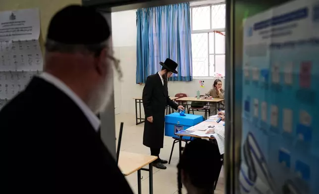 A man casts his ballot at a polling station during Israel's general election in Haifa, Israel, Tuesday, Oct. 27, 2026. (AP Photo/Baz Ratner)