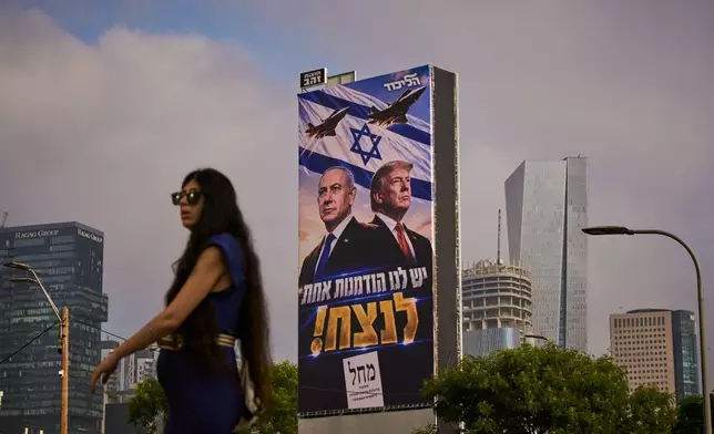 A woman walks past a Likud Party campaign billboard featuring U.S. President Donald Trump and Israeli Prime Minister Benjamin Netanyahu, with a Hebrew message reading, "We have one opportunity to win," in Tel Aviv, Israel, Monday, Oct. 26, 2026. (AP Photo/Oded Balilty)