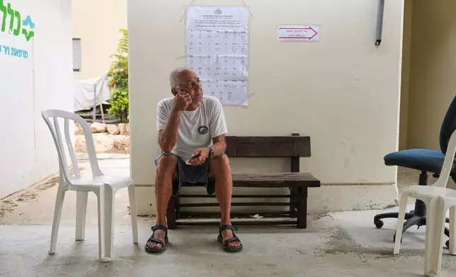 Former Israeli hostage Gadi Moses waits to cast his ballot during Israel's general election at a polling station in Kibbutz Nir Oz, southern Israel, Tuesday, Oct. 27, 2026. (AP Photo/Ariel Schalit)