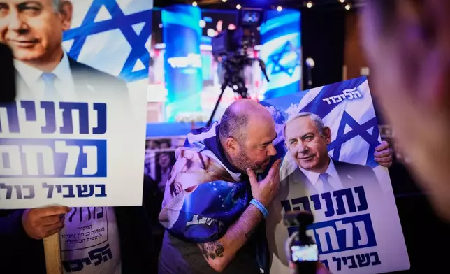 Supporters of Israeli Prime Minister Benjamin Netanyahu react to the release of the first exit poll results in Israel's general election in Jerusalem on Tuesday, Oct. 27, 2026. (AP Photo/Ohad Zwigenberg)