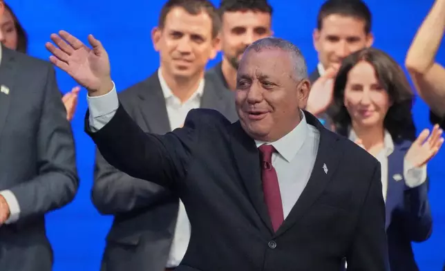 Gadi Eisenkot, leader of the Yashar ("Straight") party, waves to supporters after the release of the first exit poll results in Israel's general election in Tel Aviv, Israel, Tuesday, Oct. 27, 2026. (AP Photo/Ariel Schalit)