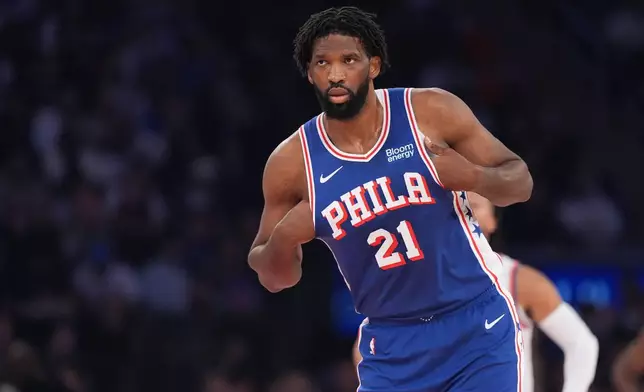 Philadelphia 76ers center Joel Embiid looks on during the first half of an NBA basketball game against the New York Knicks Tuesday, Oct. 20, 2026, in New York. (AP Photo/Frank Franklin II)