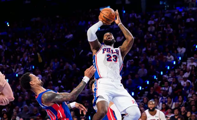 Philadelphia 76ers' LeBron James (23) shoots against Detroit Pistons' John Collins, left, during the second half of an NBA basketball game, Sunday, Oct. 25, 2026, in Philadelphia. (AP Photo/Chris Szagola)