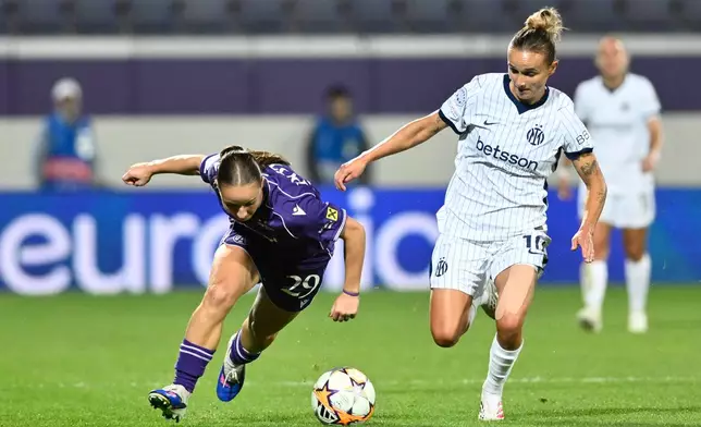 Austria Wien's Valentina Potzl and Inter's Lina Magull challenge for the ball during the Women's Champions League opening-phase soccer match between Austria Wien and Inter in Vienna, Austria, Thursday, Oct. 1, 2026. (AP Photo/Denes Erdos)