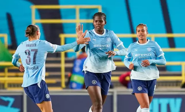 Manchester City's Khadija Shaw, centre, celebrates after scoring her side's opening goal during the Women's Champions League opening phase soccer match between Manchester City and Real Madrid in Manchester, England, Thursday, Oct. 1, 2026. (AP Photo/Dave Thompson)
