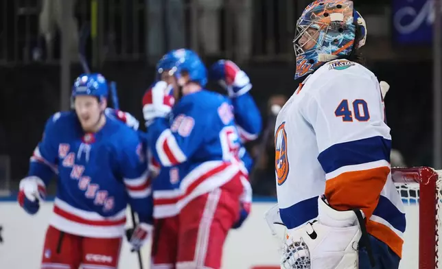 New York Islanders goaltender Semyon Varlamov (40) reacts as the New York Rangers celebrate a goal by Oliver Bjorkstrand during the second period of an NHL hockey game Tuesday, Oct. 6, 2026, in New York. (AP Photo/Frank Franklin II)