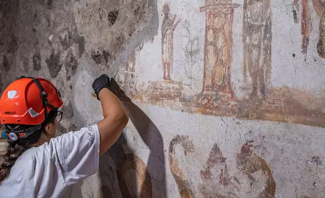In this undated handout photo provided on Tuesday, Oct. 20, 2026, by the Pompeii Archaeological Park, restorers work inside the House of Marcus Fabius Rufus in Pompeii, near Naples, Italy. (Silvia Vacca/ Pompeii Archaeological Park via AP)