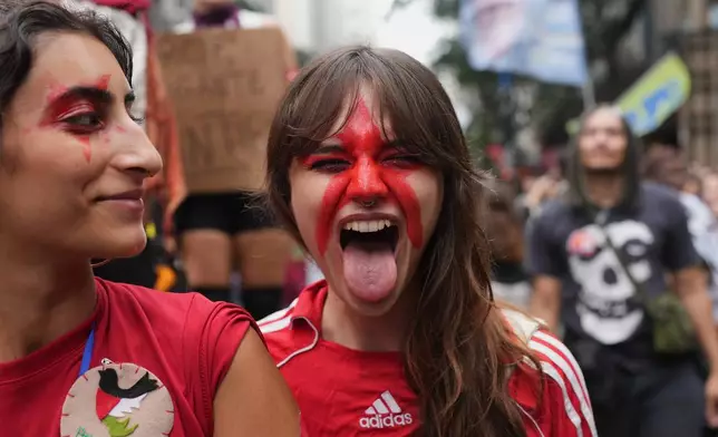 A demonstrator wears the red star of the Worker's Party during a student march to defend public education and support Brazilian President Luiz Inacio Lula da Silva, who is running for a fourth term, ahead of the presidential runoff election in Rio de Janeiro, Wednesday, Oct. 7, 2026. (AP Photo/Silvia Izquierdo)