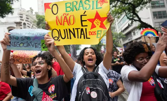 Students carry a sign that reads in Portuguese: "Brazil is not the backyard of the U.S." as they march to defend public education and support Brazilian President Luiz Inacio Lula da Silva, who is running for a fourth term, ahead of the presidential runoff election in Rio de Janeiro, Wednesday, Oct. 7, 2026. (AP Photo/Silvia Izquierdo)