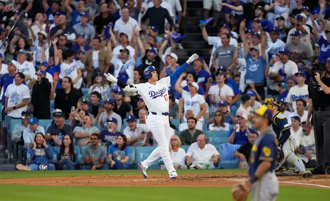 Los Angeles Dodgers designated hitter Shohei Ohtani celebrates his three run home during the second inning of Game 4 of baseball's National League Championship Series between the Milwaukee Brewers and the Los Angeles Dodgers, Thursday, Oct. 15, 2026, in Los Angeles. (AP Photo/Mark J. Terrill)