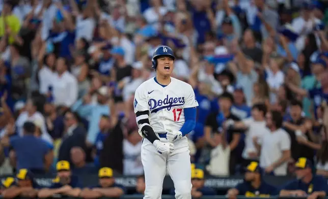 Los Angeles Dodgers designated hitter Shohei Ohtani celebrates his three run home run during the second inning of Game 4 of baseball's National League Championship Series between the Milwaukee Brewers and the Los Angeles Dodgers, Thursday, Oct. 15, 2026, in Los Angeles. (AP Photo/Gregory Bull)