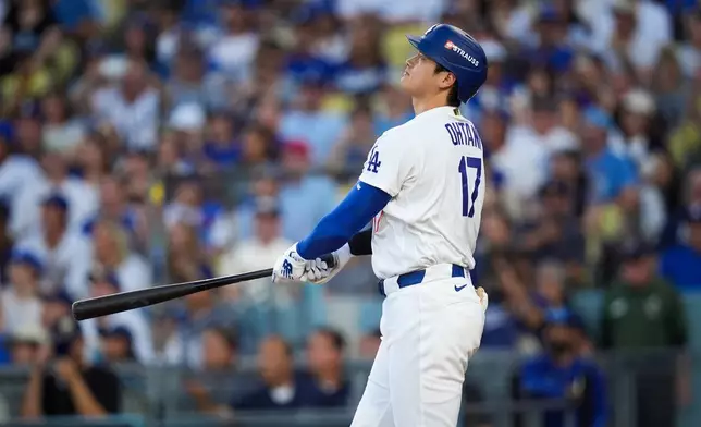 Los Angeles Dodgers designated hitter Shohei Ohtani follows through on a three run home run during the second inning of Game 4 of baseball's National League Championship Series between the Milwaukee Brewers and the Los Angeles Dodgers, Thursday, Oct. 15, 2026, in Los Angeles. (AP Photo/Gregory Bull)