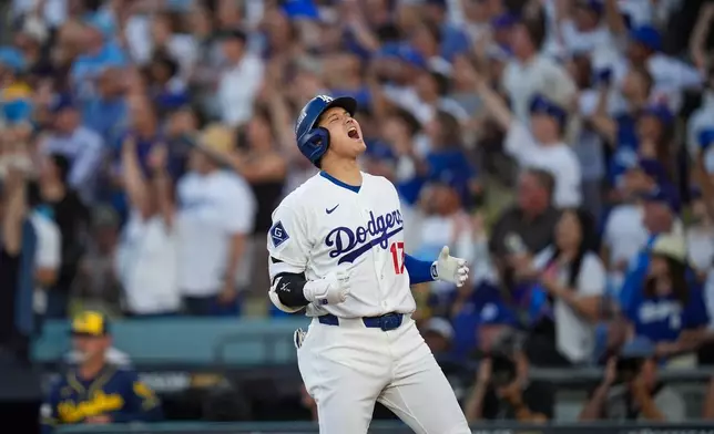 Los Angeles Dodgers designated hitter Shohei Ohtani celebrates his three run home run during the second inning of Game 4 of baseball's National League Championship Series between the Milwaukee Brewers and the Los Angeles Dodgers, Thursday, Oct. 15, 2026, in Los Angeles. (AP Photo/Gregory Bull)