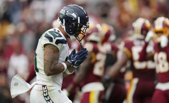Seattle Seahawks wide receiver Jaxon Smith-Njigba (11) celebrates after scoring a touchdown against the Washington Commanders during the second half of an NFL football game Sunday, Sept. 27, 2026 in Landover, Md. (AP Photo/Stephanie Scarbrough)