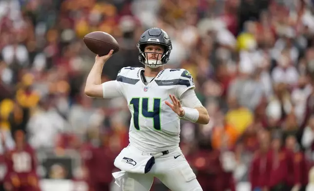 Seattle Seahawks quarterback Sam Darnold (14) throws the ball during the second half of an NFL football game against Washington Commanders, Sunday, Sept. 27, 2026 in Landover, Md. (AP Photo/Stephanie Scarbrough)