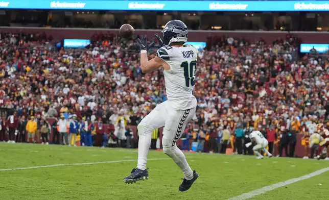 Seattle Seahawks wide receiver Cooper Kupp (10) scoring a touchdown during the second half of an NFL football game against the Washington Commanders, Sunday, Sept. 27, 2026 in Landover, Md. (AP Photo/Stephanie Scarbrough)