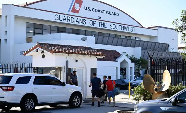 Traffic passes through the front gate at Coast Guard Station San Diego, Friday, Oct. 16, 2026, in San Diego. (AP Photo/Denis Poroy)