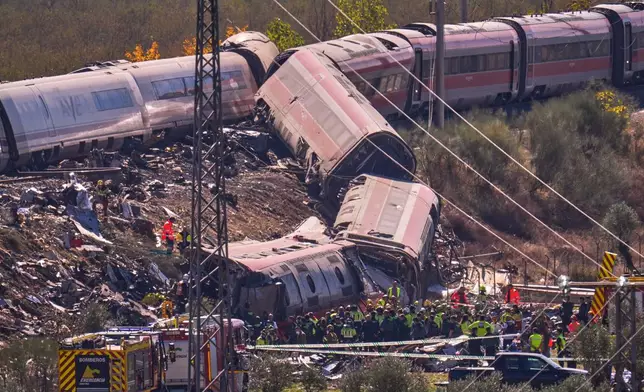Emergency services work at the scene of a collision between two trains in Urda, Spain, on Wednesday, Oct. 28, 2026. (AP Photo/Manu Fernandez)