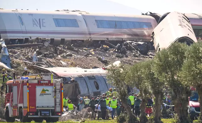 Emergency services work at the scene of a collision between two trains in Urda, Spain, Wednesday, Oct. 28, 2026. (AP Photo/Manu Fernandez)