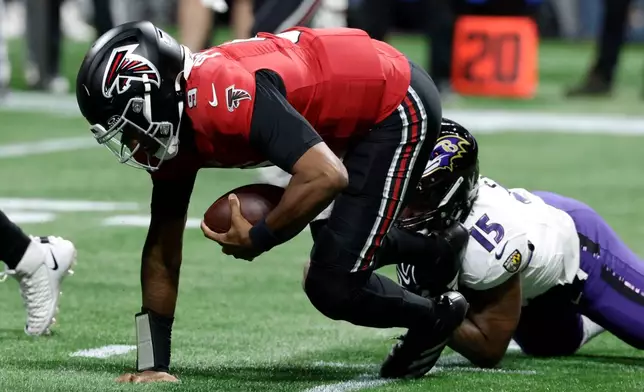 Atlanta Falcons quarterback Michael Penix Jr. (9) is sacked by Baltimore Ravens linebacker Mike Green (15) during the first half of an NFL football game, Sunday, Oct. 11, 2026, in Atlanta. (AP Photo/Erik S. Lesser)