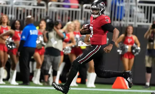 Atlanta Falcons quarterback Michael Penix Jr. runs up field during the first half of an NFL football game against the Baltimore Ravens, Sunday, Oct. 11, 2026, in Atlanta. (AP Photo/Mike Stewart)