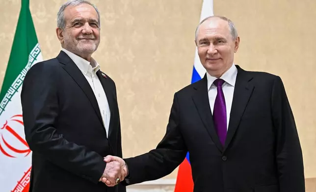 Russian President Vladimir Putin, right, and Iranian President Masoud Pezeshkian pose for a photo on the sidelines of the Commonwealth of Independent States (CIS) summit in Türkmenbaşy, Turkmenistan, Thursday, Oct. 8, 2026. (Sergei Bobylev, Sputnik, Kremlin Pool Photo via AP)