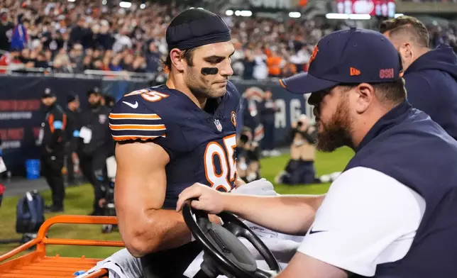 Chicago Bears tight end Cole Kmet (85) is carted off the field after suffering an injury on a pass play during the second half of an NFL football game against the New England Patriots in Chicago, Thursday, Oct. 22, 2026. (AP Photo/Nam Y. Huh)