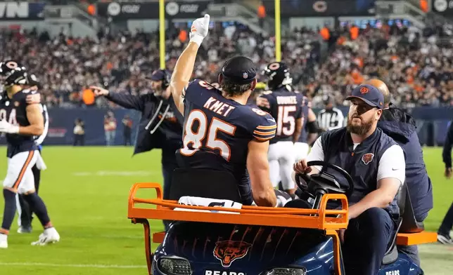 Chicago Bears tight end Cole Kmet (85) gives a thumbs up as he is carted off the field after suffering an injury during the second half of an NFL football game against the New England Patriots in Chicago, Thursday, Oct. 22, 2026. (AP Photo/Nam Y. Huh)