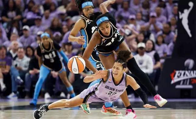Golden State Valkyries guard Veronica Burton (22) and Atlanta Dream forward Angel Reese (5) compete for possession of the ball during the first half of Game 5 of the WNBA basketball finals in San Francisco, Monday, Oct. 26, 2026. (Stephen Lam/San Francisco Chronicle via AP)