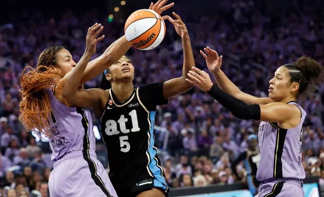 Atlanta Dream forward Angel Reese (5) and Golden State Valkyries center Kiah Stokes, left, compete for possession of the ball during the first half of Game 5 of the WNBA basketball finals in San Francisco, Monday, Oct. 26, 2026. (Stephen Lam/San Francisco Chronicle via AP)
