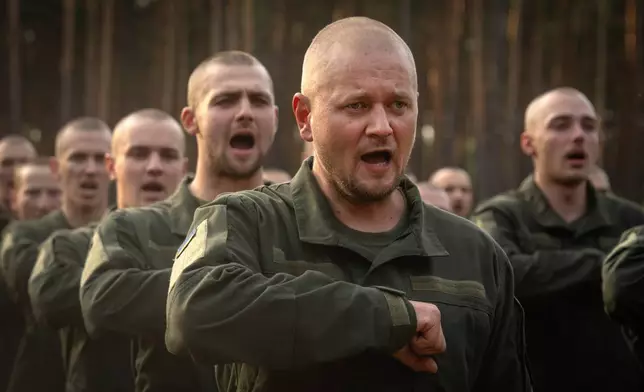 FILE - Newly recruited soldiers toss their hats as they celebrate the end of their training at a military base close to Kyiv, Ukraine, Monday, Sept. 25, 2023. (AP Photo/Efrem Lukatsky, File)