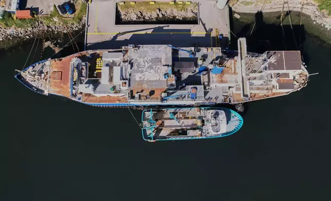 The F/V Progress, bottom, delivers its catch to a processing vessel in Dutch Harbor, Alaska, Friday, July 24, 2026. (AP Photo/Annika Hammerschlag)