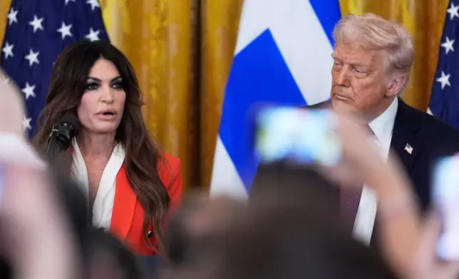 FILE - Kimberly Guilfoyle speaks as President Donald Trump listens at a reception celebrating Greek Independence Day in the East Room of the White House, March 24, 2025, in Washington. (AP Photo/Mark Schiefelbein, File)