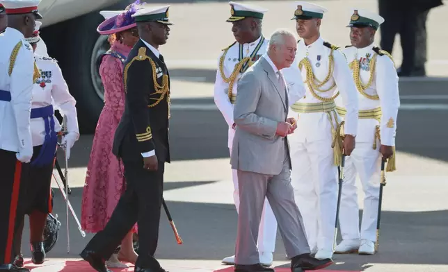 Britain's King Charles III arrives at the Lynden Pindling Airport in Nassau, Bahamas, Tuesday, Oct. 27, 2026. (AP Photo/Tim Aylen)