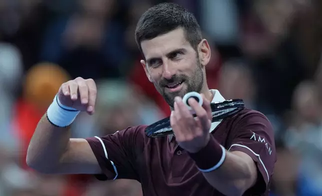 Novak Djokovic, of Serbia, celebrates after defeating Alexander Zverev, of Germany, in the men's singles quarterfinals match at the China Open tennis tournament in Beijing, Sunday, Oct. 4, 2026. (AP Photo/Achmad Ibrahim)