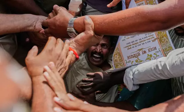 Socialist, left-wing parties and student activists shout slogans as police detain them during a protest against Chief Election Commissioner Gyanesh Kumar and calling for the suspension of the Special Intensive Revision (SIR) of electoral rolls in New Delhi, India, Friday, Oct. 2, 2026. (AP Photo/Manish Swarup)