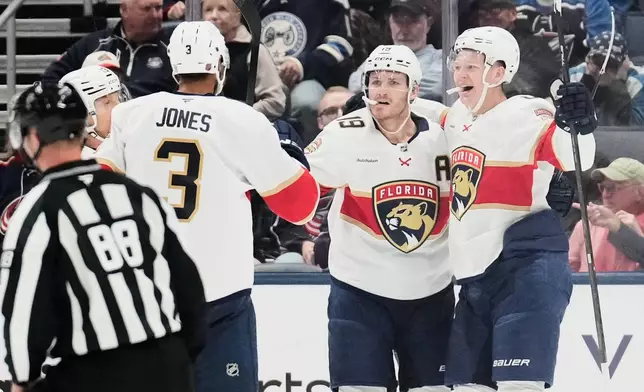 Florida Panthers left wing Brady Tkachuk, right, celebrates his goal against the Columbus Blue Jackets with Seth Jones (3) and Matthew Tkachuk (19) in the second period of an NHL hockey game in Columbus, Ohio, Tuesday, Oct. 13, 2026. (AP Photo/Sue Ogrocki)