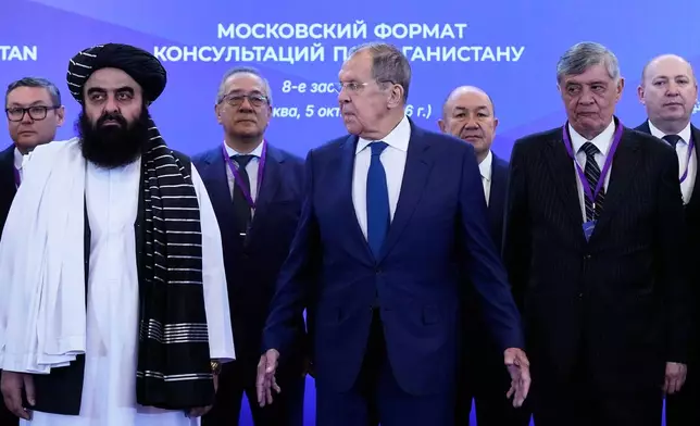 Front, from left, Afghanistan's Foreign Minister Amir Khan Muttaqi, Russian Foreign Minister Sergey Lavrov and Russian Presidential Envoy to Afghanistan Zamir Kabulov pose for a photo ahead of the Moscow format consultations on Afghanistan in Moscow, Monday, Oct. 5, 2026. (AP Photo/Alexander Zemlianichenko)