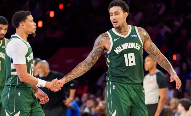 Milwaukee Bucks' Ryan Rollins, left, celebrates his basket with Kyle Kuzma, right, during the first half of an NBA basketball game against the Philadelphia 76ers, Saturday, Oct. 24, 2026, in Philadelphia. (AP Photo/Chris Szagola)