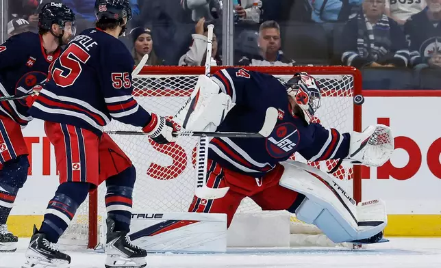 Winnipeg Jets goaltender Stuart Skinner (74) saves the Colorado Avalanche shot during the second period of an NHL hockey game in Winnipeg, Wednesday, Oct. 7, 2026. (John Woods/The Canadian Press via AP)