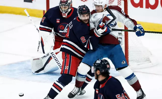 Winnipeg Jets' Dylan DeMelo (2) defends against Colorado Avalanche's Artturi Lehkonen (62) during the first period of an NHL hockey game in Winnipeg, Wednesday, Oct. 7, 2026. (John Woods/The Canadian Press via AP)